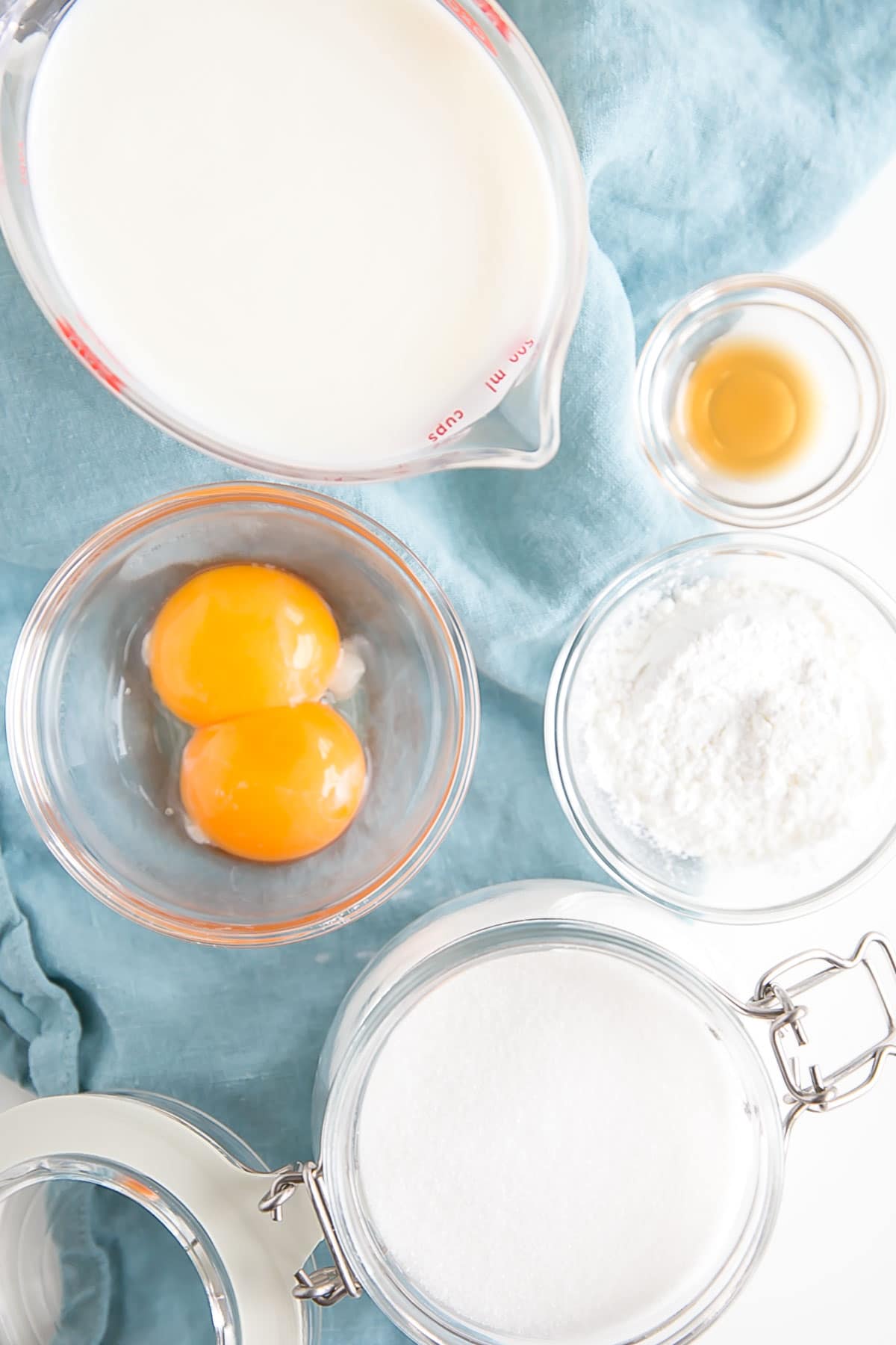 This easy Pastry Cream (Creme Patissiere) recipe is simple and delicious. A rich and creamy vanilla custard you can use in a variety of decadent desserts. | livforcake.com Picture of the ingredients needed to make vanilla custard.